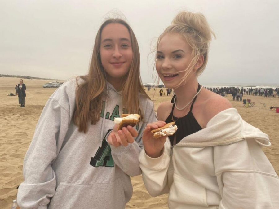 Paula, left, and Anne, right, enjoy a bonfire at the beach last weekend.  The two met at SMHS as new foreign exchange students. The two girls will be studying here until June. 
