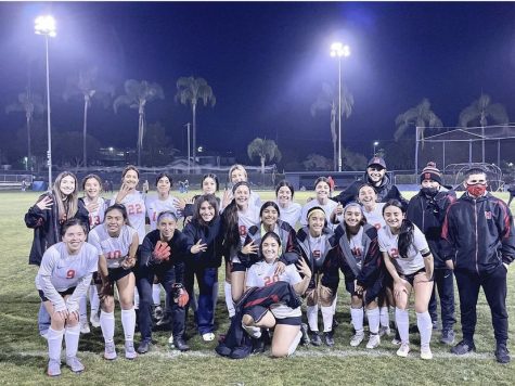 The girls Soccer team and their coaches posing for a picture after winning against Mission Prep