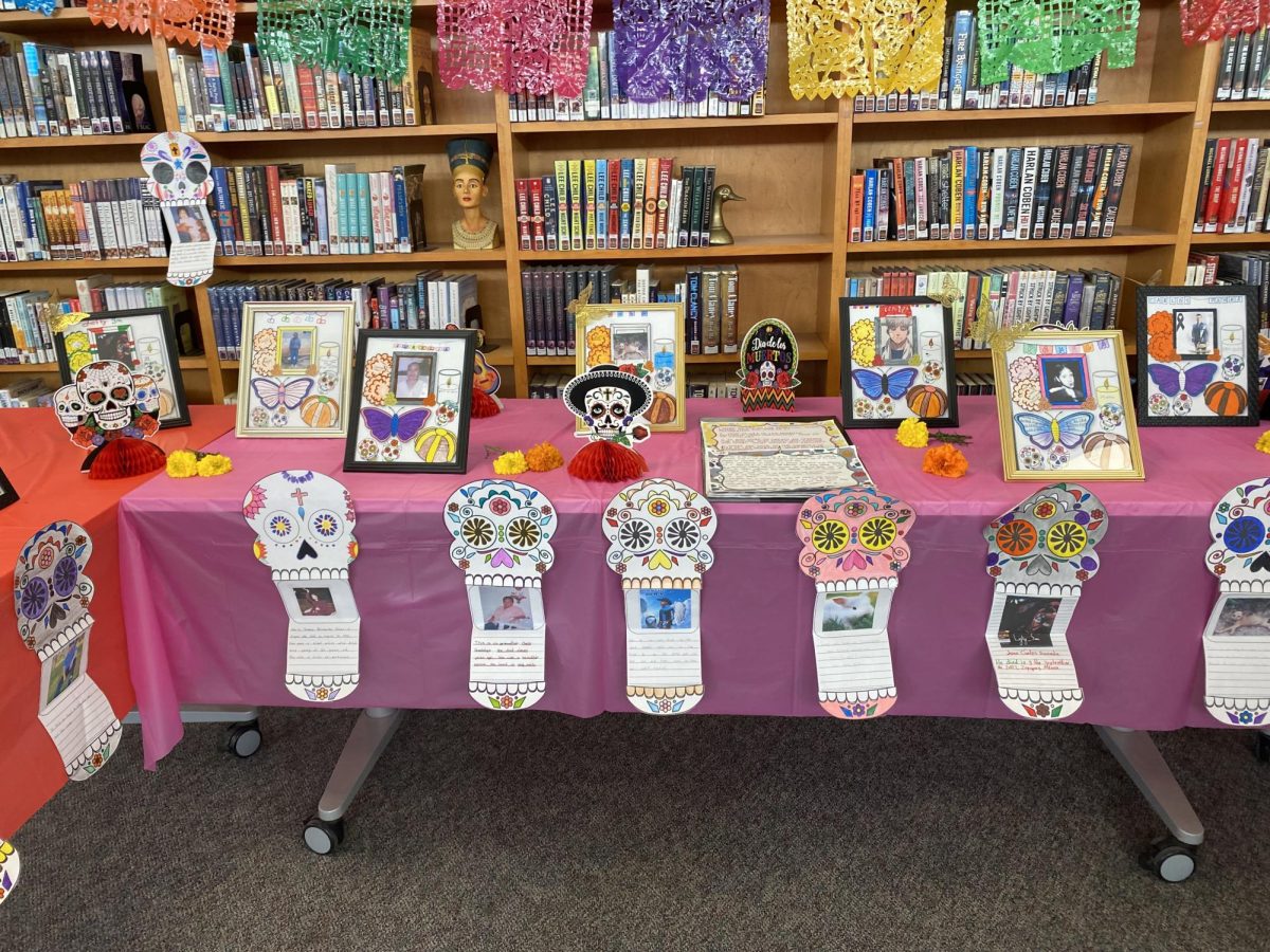 This is another table in the library that has some picture frames with their person who passed away.