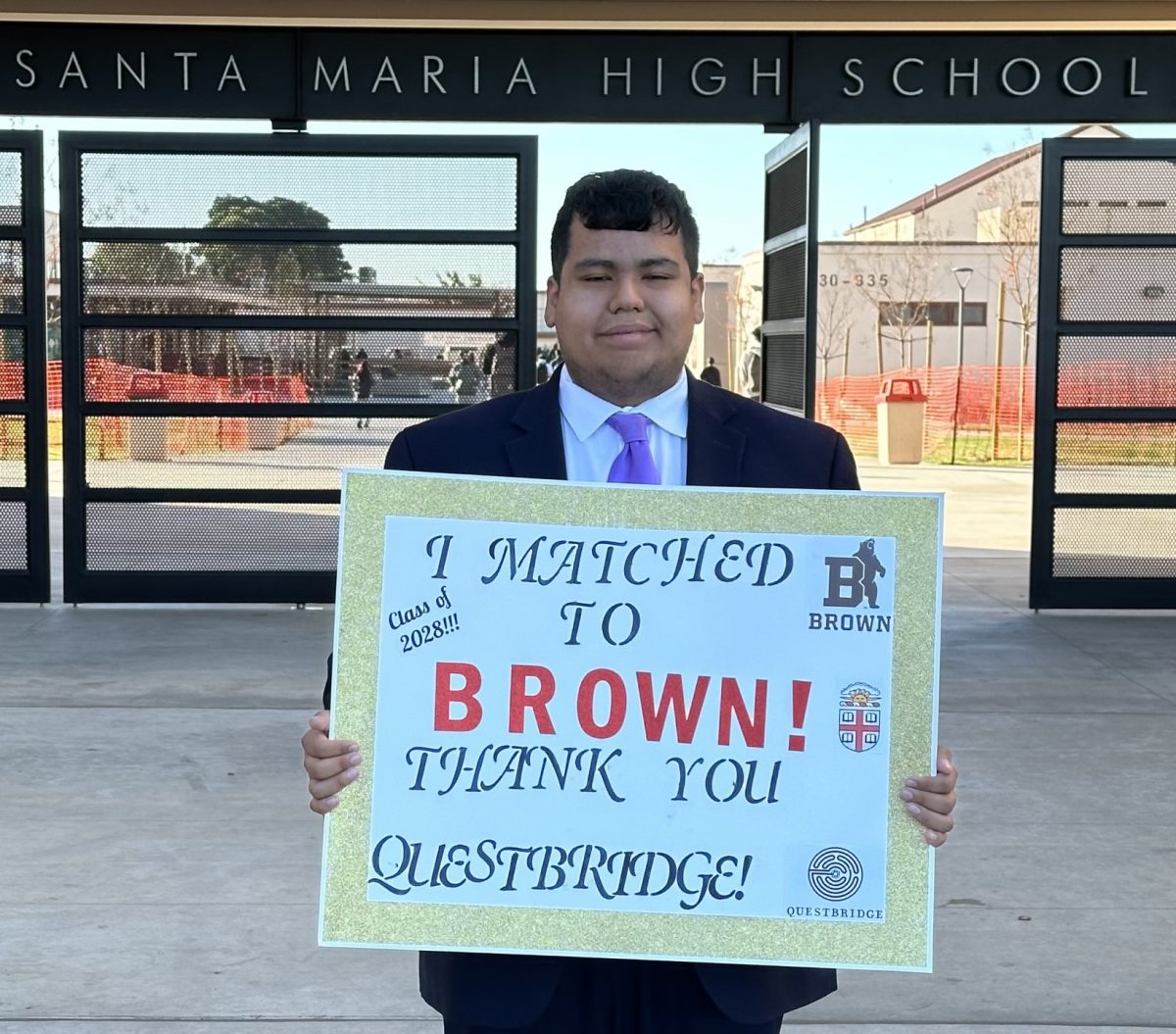 Santa Maria High School Senior Student Abraham Carrillo holding a poser, showing us that hes been match to Brown by QuestBridge. Photo Provided By Ms. Pineda
