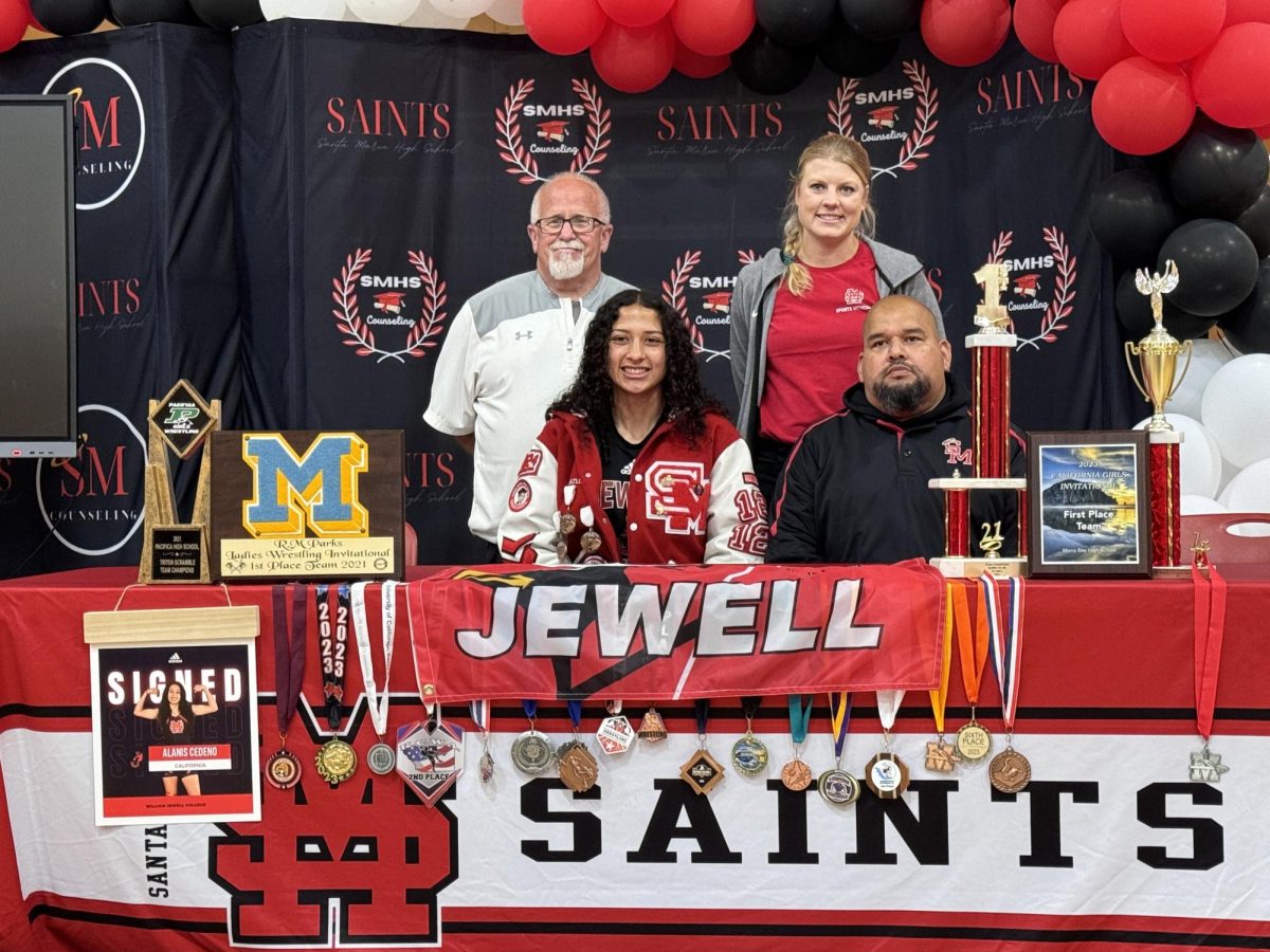 Alanis Cedeno signing to wrestle at William Jewell University with her SM trainer, coach and AD
photo provided by pineda